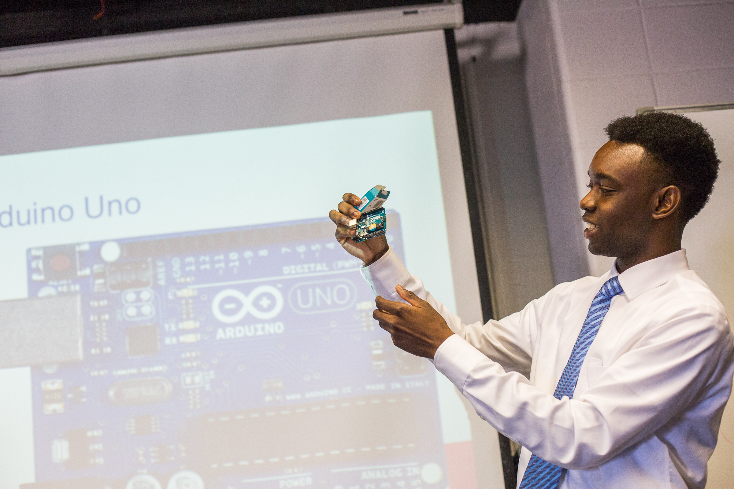 An E.N.G. student holds up an arduino used in his research